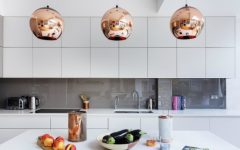A Modern Kitchen Decor with Copper Lamps and Vintage Details
